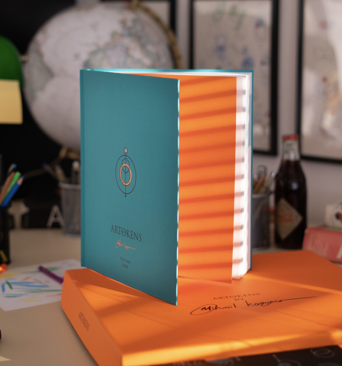 Turquoise Artokens Book Volume One with orange pages and presentation box in Mihail Korubin's studio