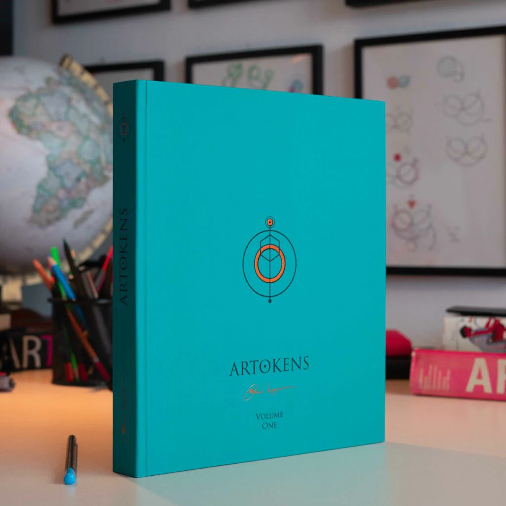 Artokens Book – Volume One with a turquoise hardcover